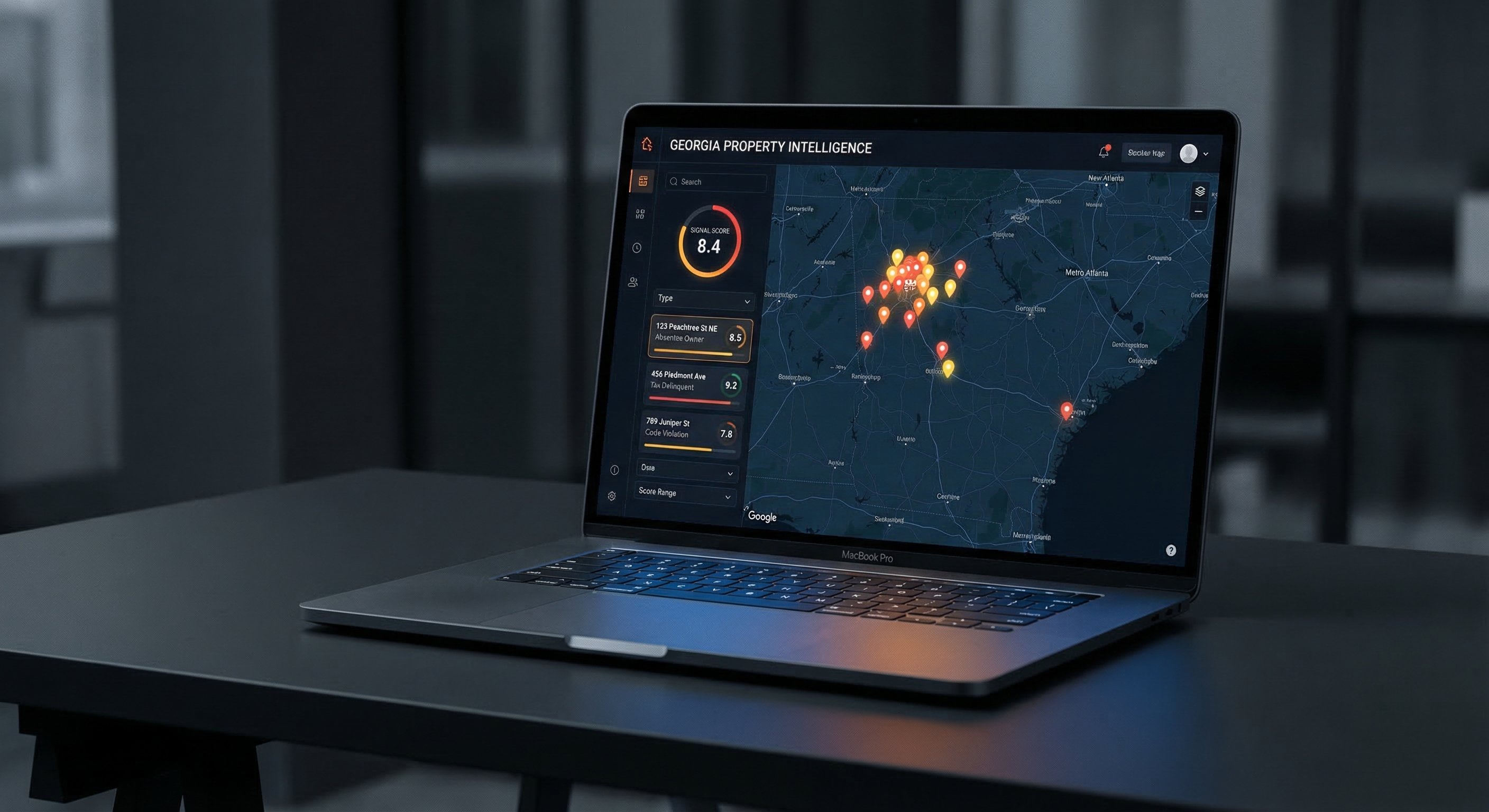 Dark-themed property intelligence dashboard on a laptop screen showing a Georgia county map with colored distress signal pins and absentee owner property filters active