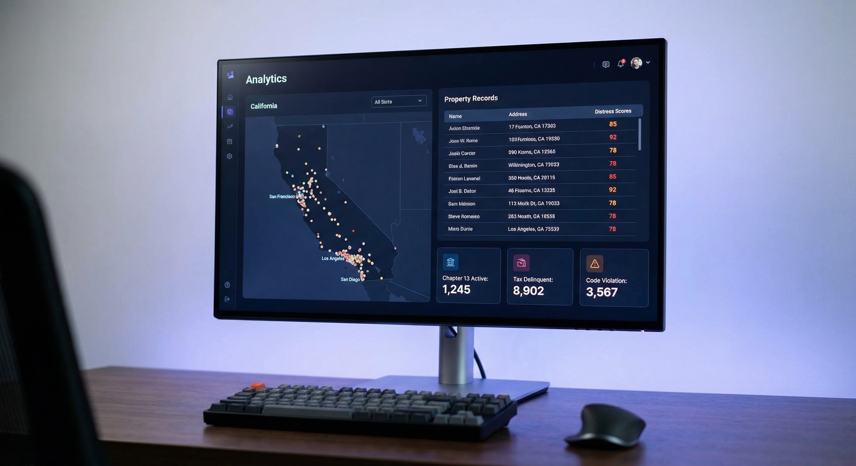 A photorealistic photograph of a modern dark-themed analytics dashboard displayed on a 27-inch monitor, showing a map of California with colored signal pins clustered in major metro areas, a list view of property records with distress scores visible, and data cards showing Chapter 13 Active, Tax Delinquent, and Code Violation status indicators, minimal modern desk setup, screen glow as key light with ambient fill, shot on Sony A7R IV with 50mm lens at f/2.8, shallow depth of field focused on the screen, technology product photography