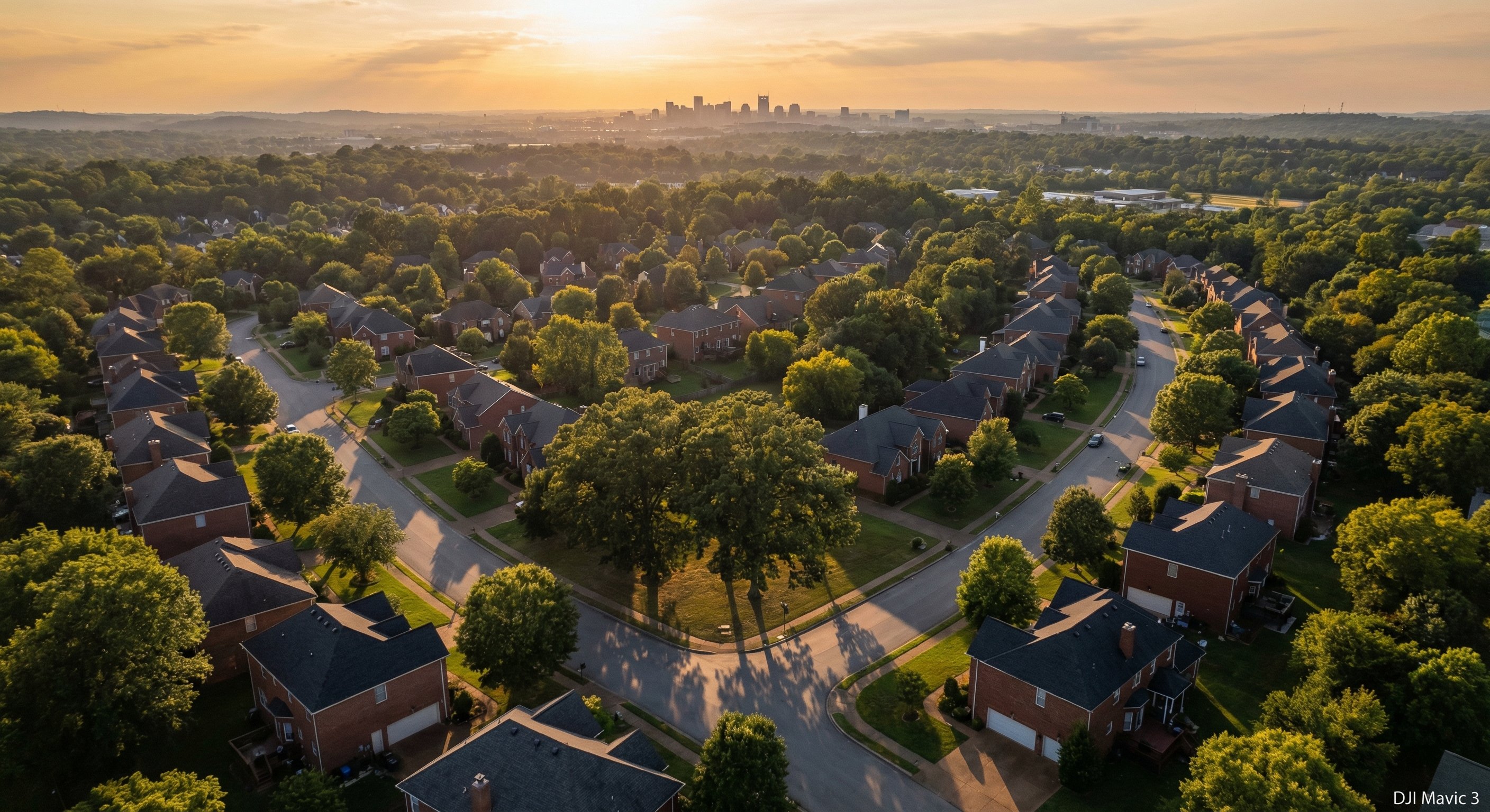 Nashville Tennessee neighborhood aerial photograph showing suburban brick homes and tree-lined streets at golden hour