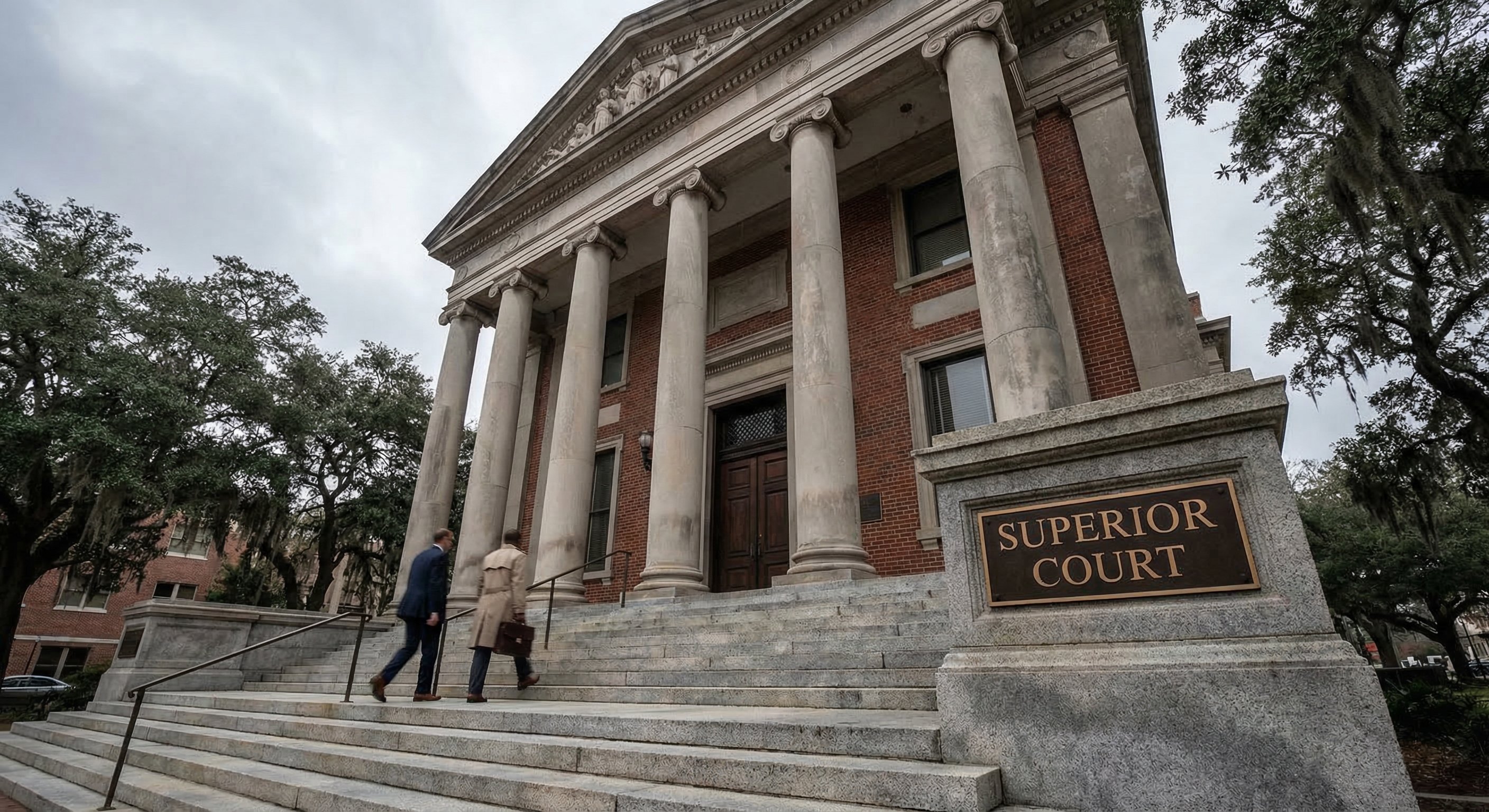 Georgia superior court building exterior with stone columns and public records signage, late morning sunlight