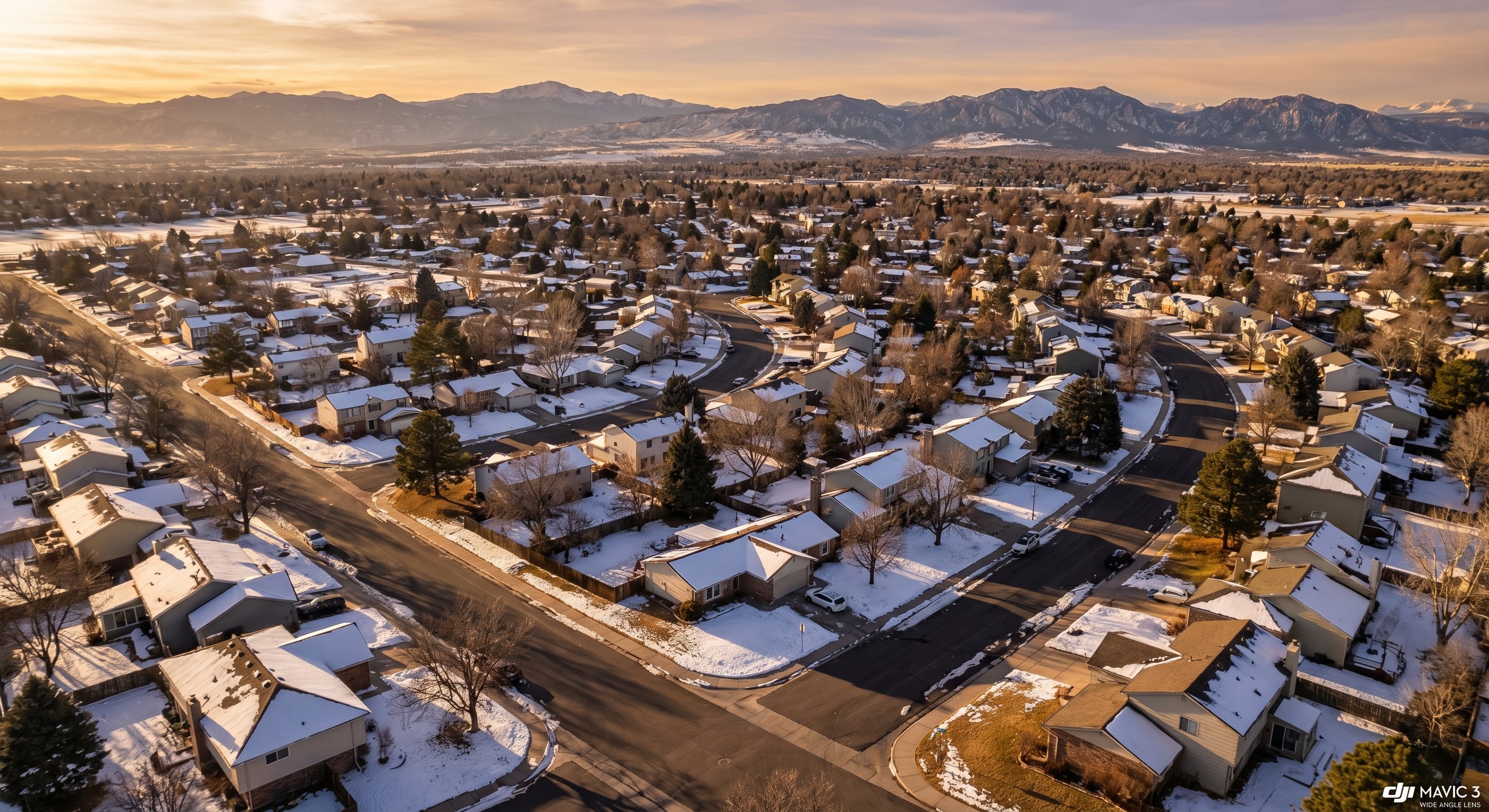 Aerial view of Colorado suburban neighborhood with Rocky Mountain backdrop