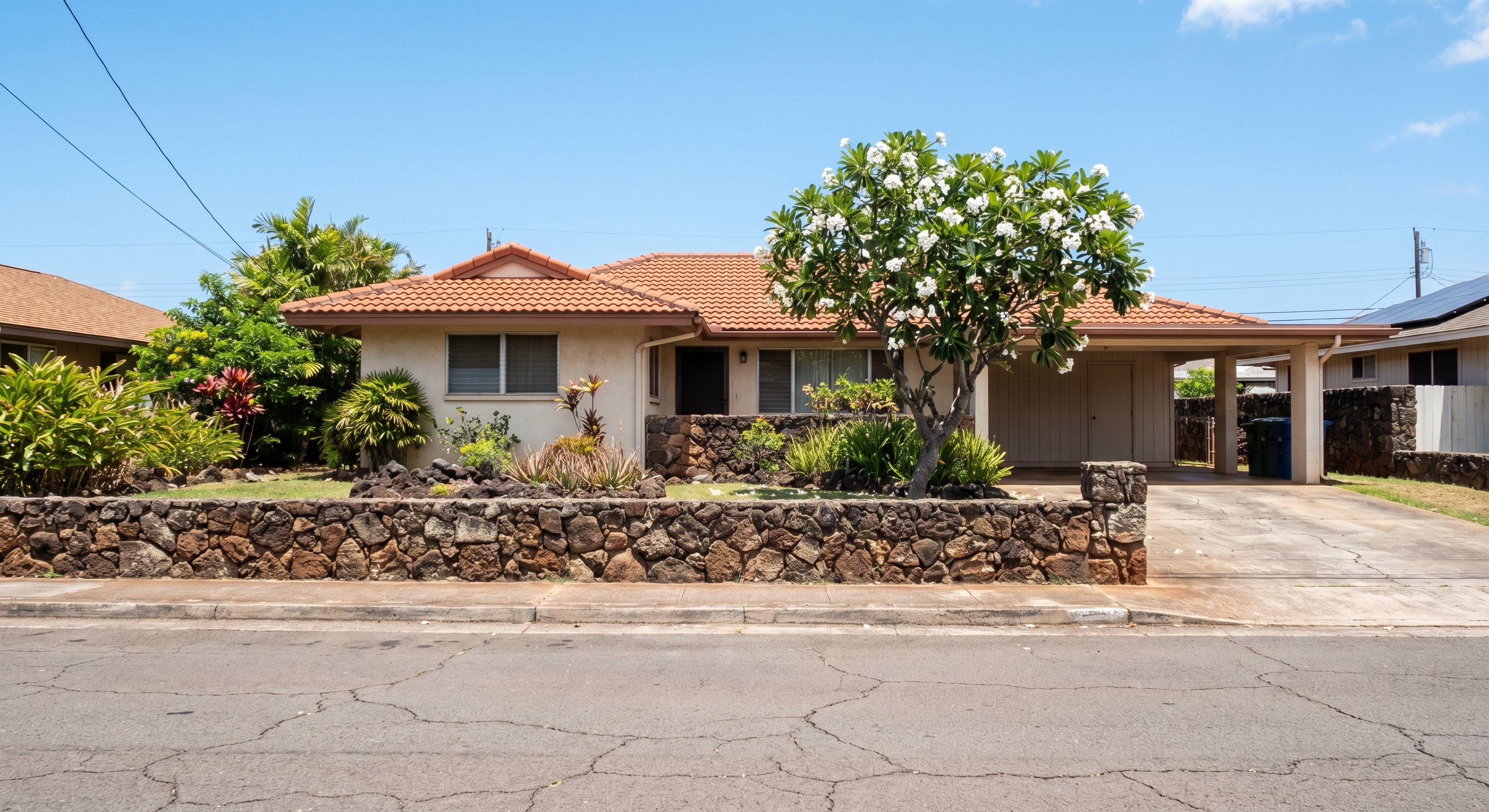 Hawaii single-story home with coral stone wall and tile roof