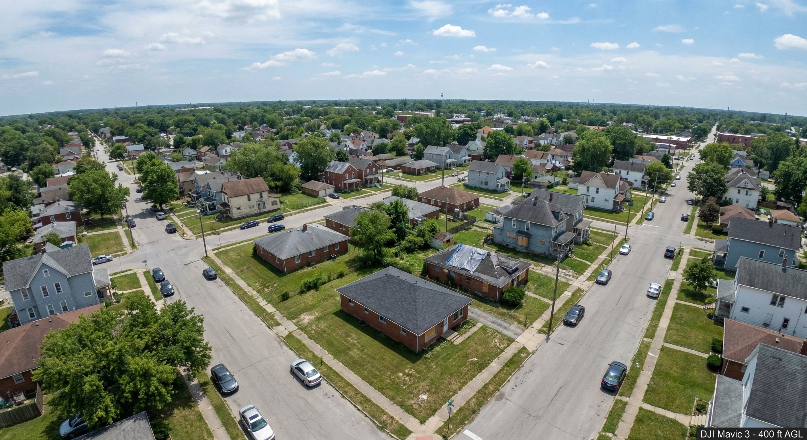 Aerial view of densely built Indiana urban neighborhood with mix of brick homes and signs of vacancy