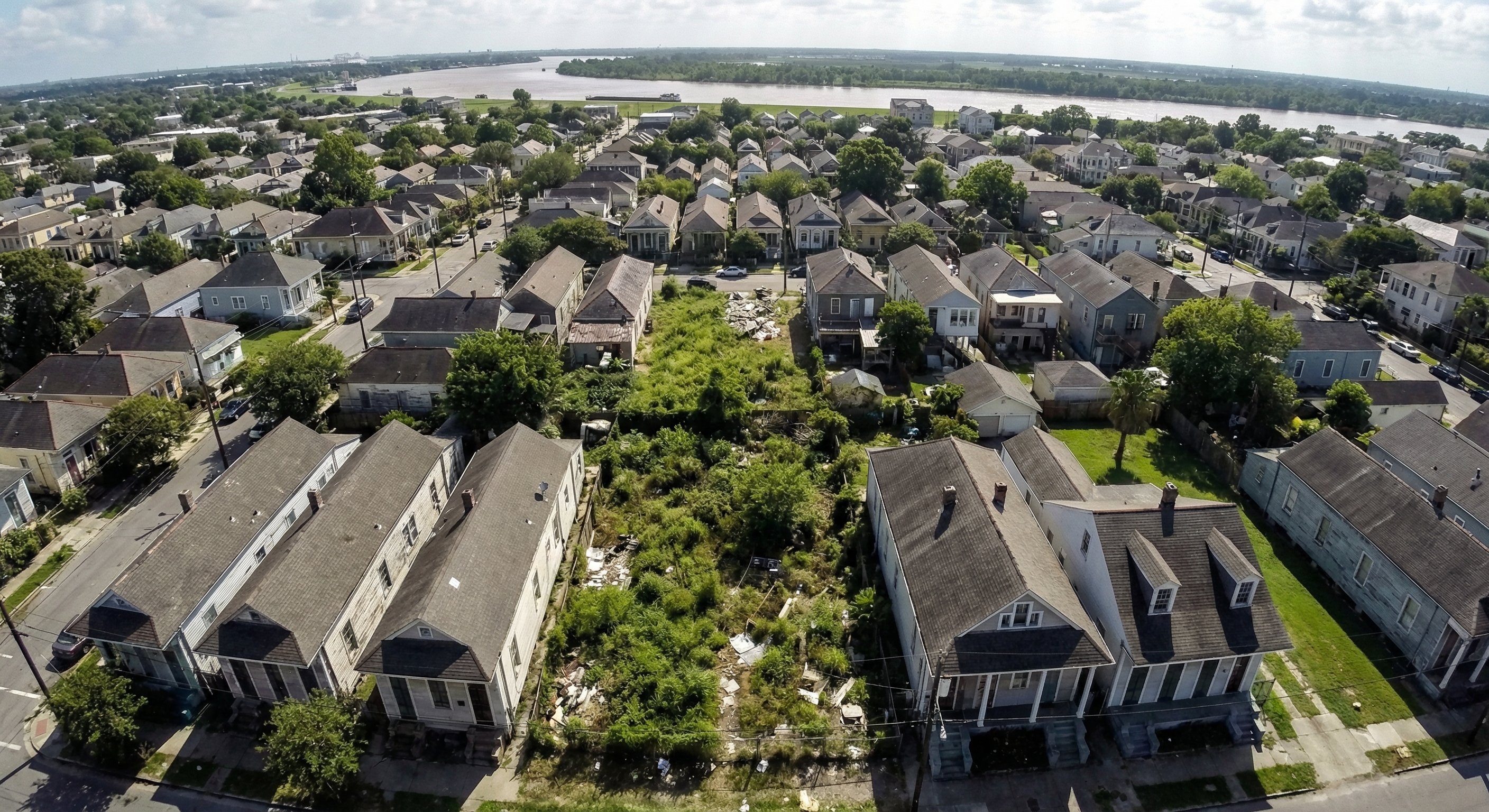 Aerial view of New Orleans neighborhood with vacant lots and shotgun homes
