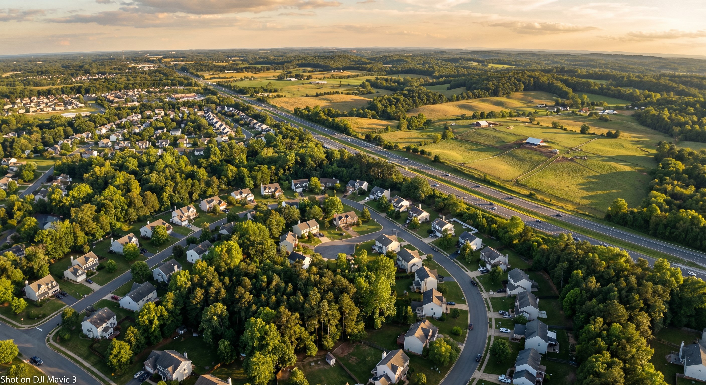 Aerial drone view of Virginia landscape transitioning from suburban neighborhoods to rural farmland