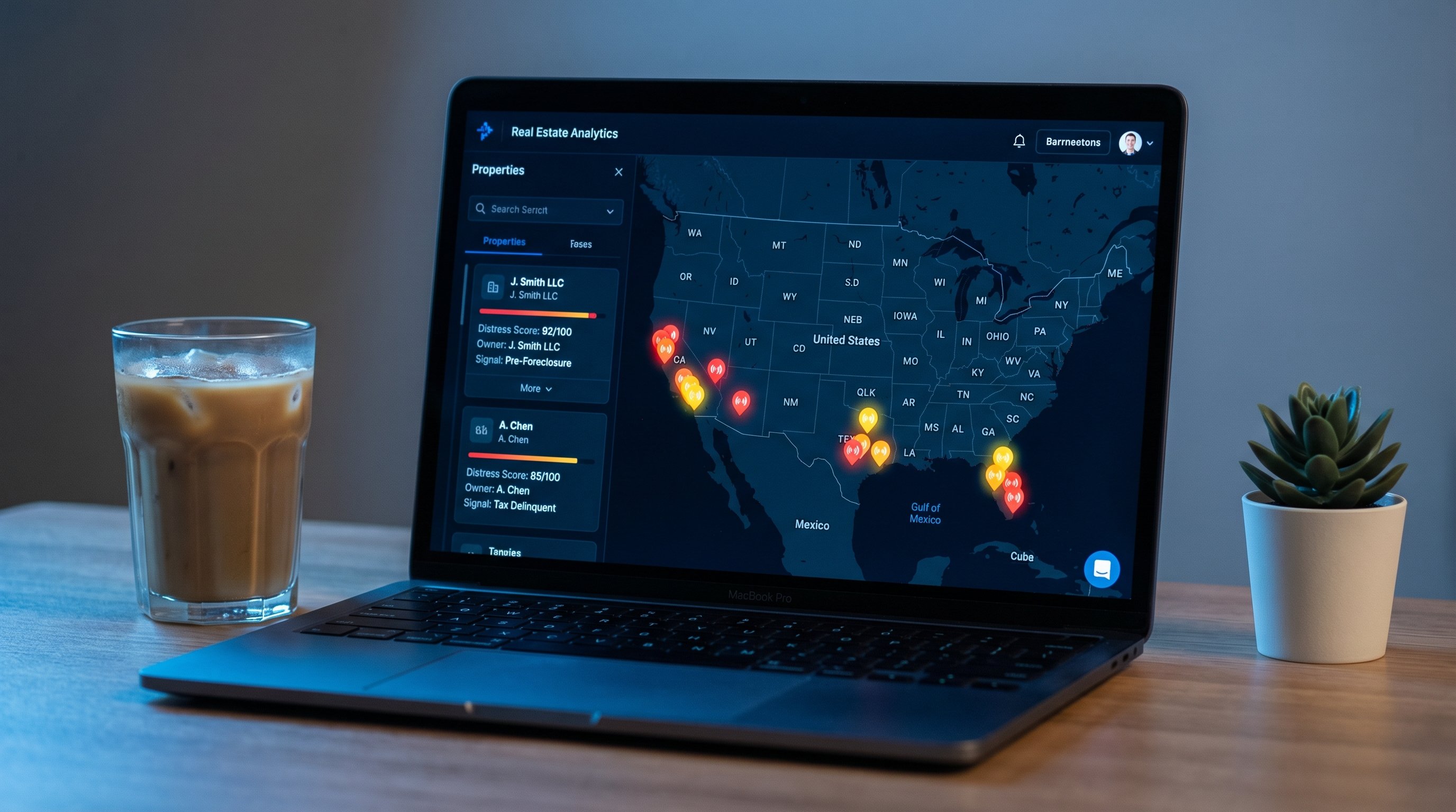Dark-themed real estate analytics dashboard on a laptop screen showing a US map with colored signal pins, property cards with distress scores and signal types