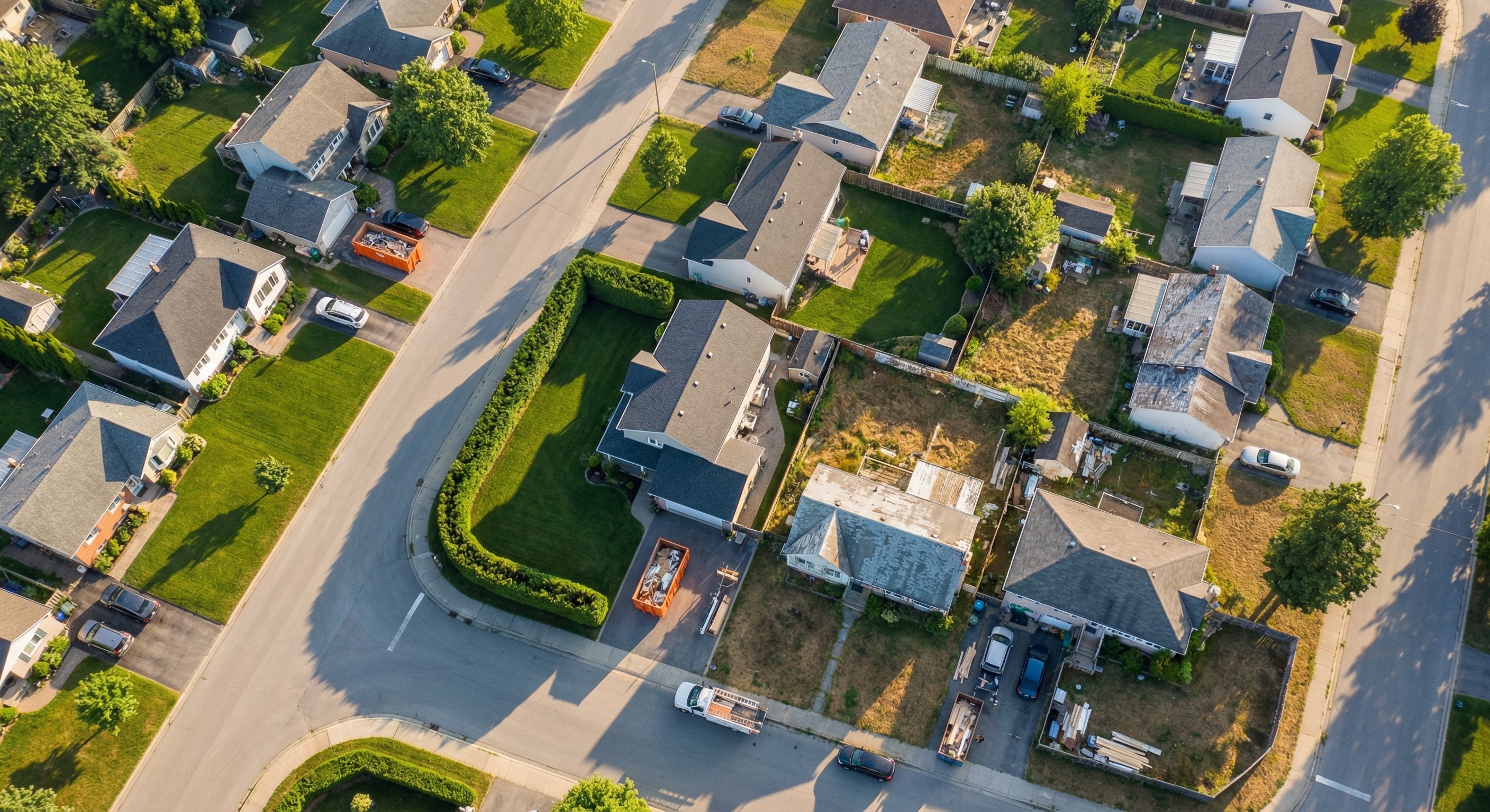 Aerial view of a residential neighborhood showing properties in various conditions