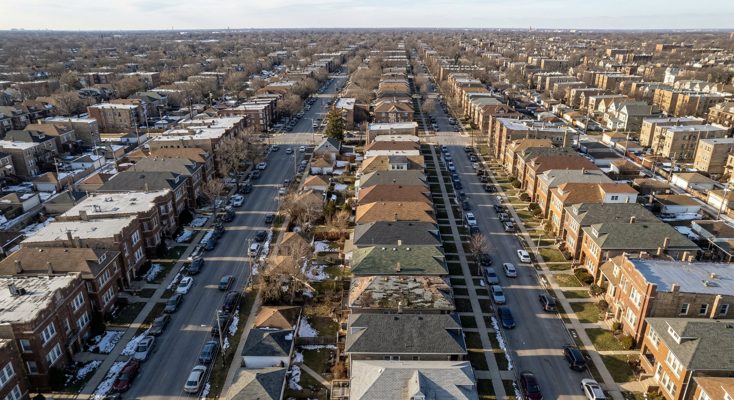 Aerial drone view of dense Chicago suburb neighborhood showing mixed property conditions from above