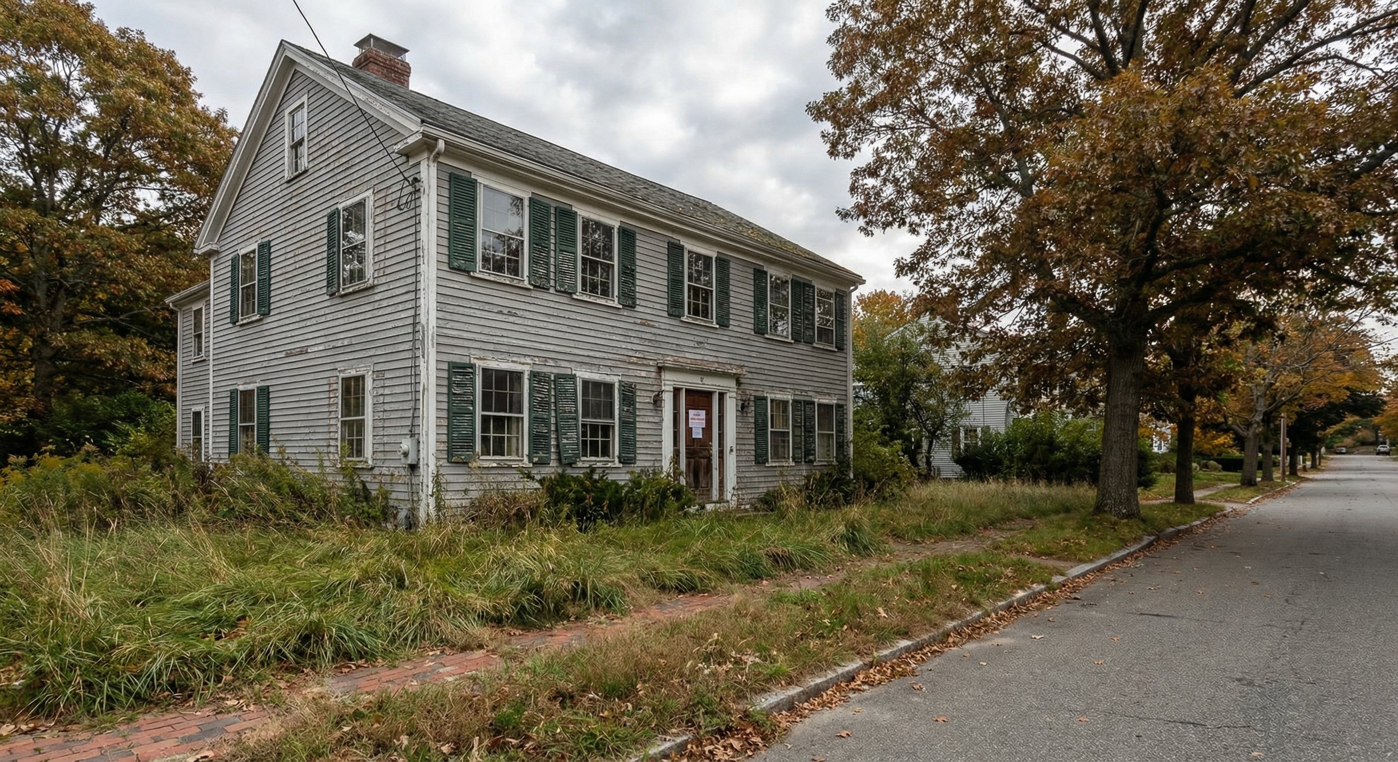 Massachusetts colonial home with pre-foreclosure notice on the door and an overgrown yard indicating owner distress