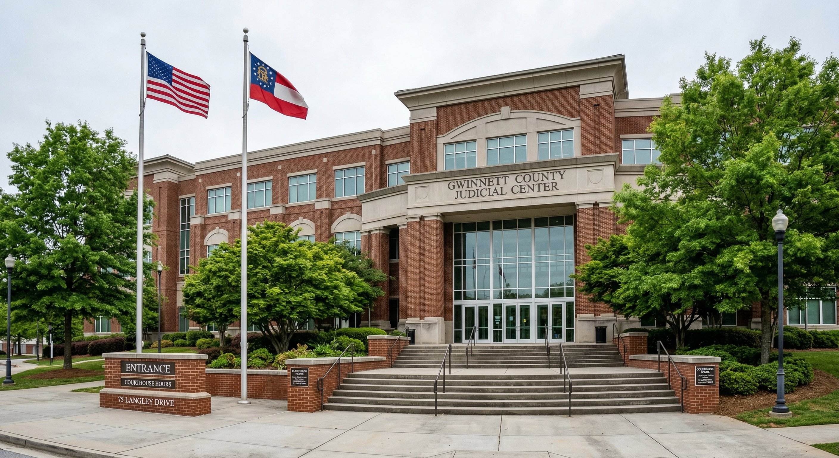 Georgia courthouse exterior — Gwinnett County Judicial Center in Lawrenceville, wide-angle shot, morning light, brick facade with public records signage visible