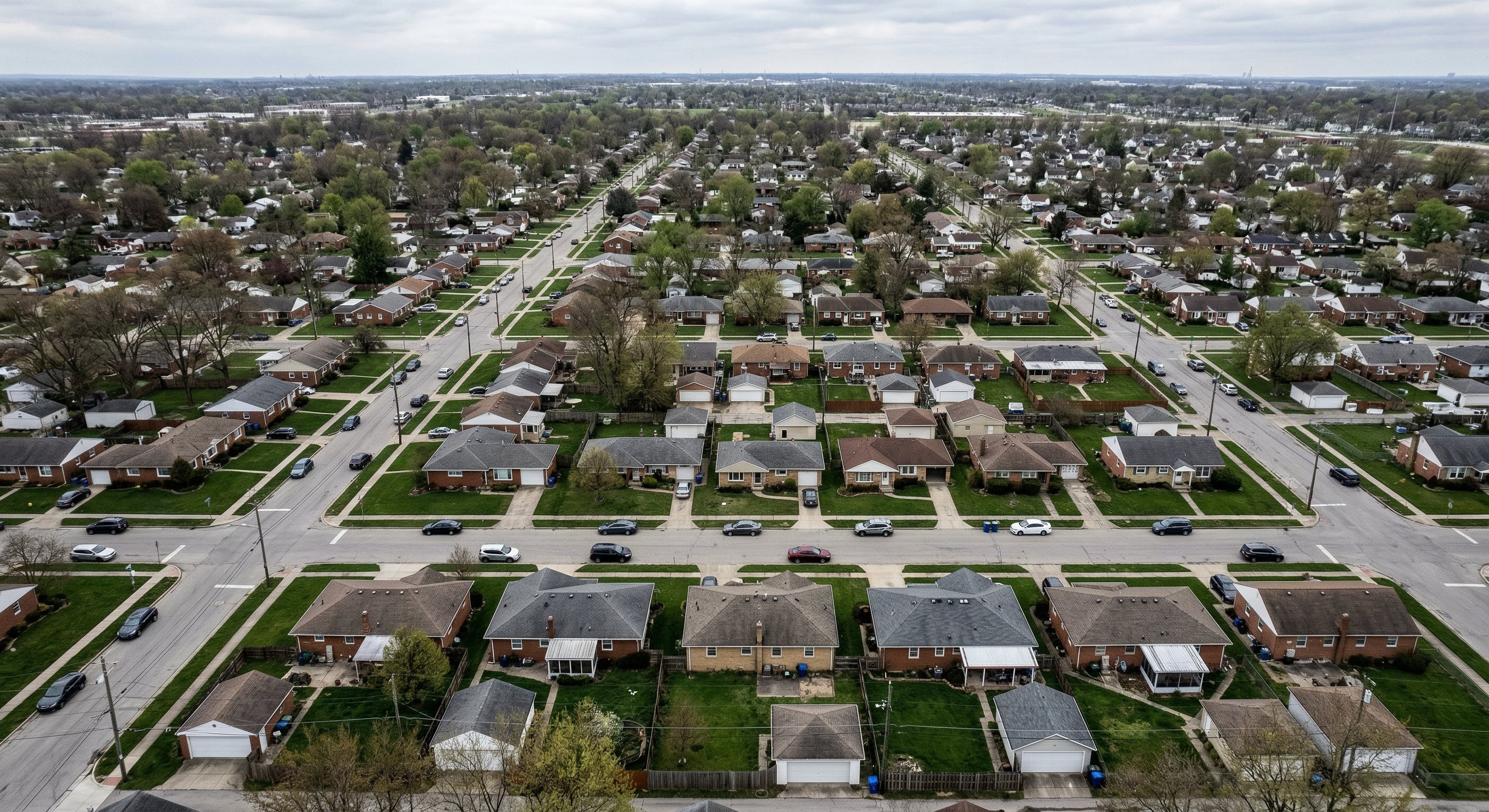 Aerial drone photograph of a residential neighborhood in Columbus, Ohio showing grid streets, mature tree canopy, and older housing stock from 200 feet