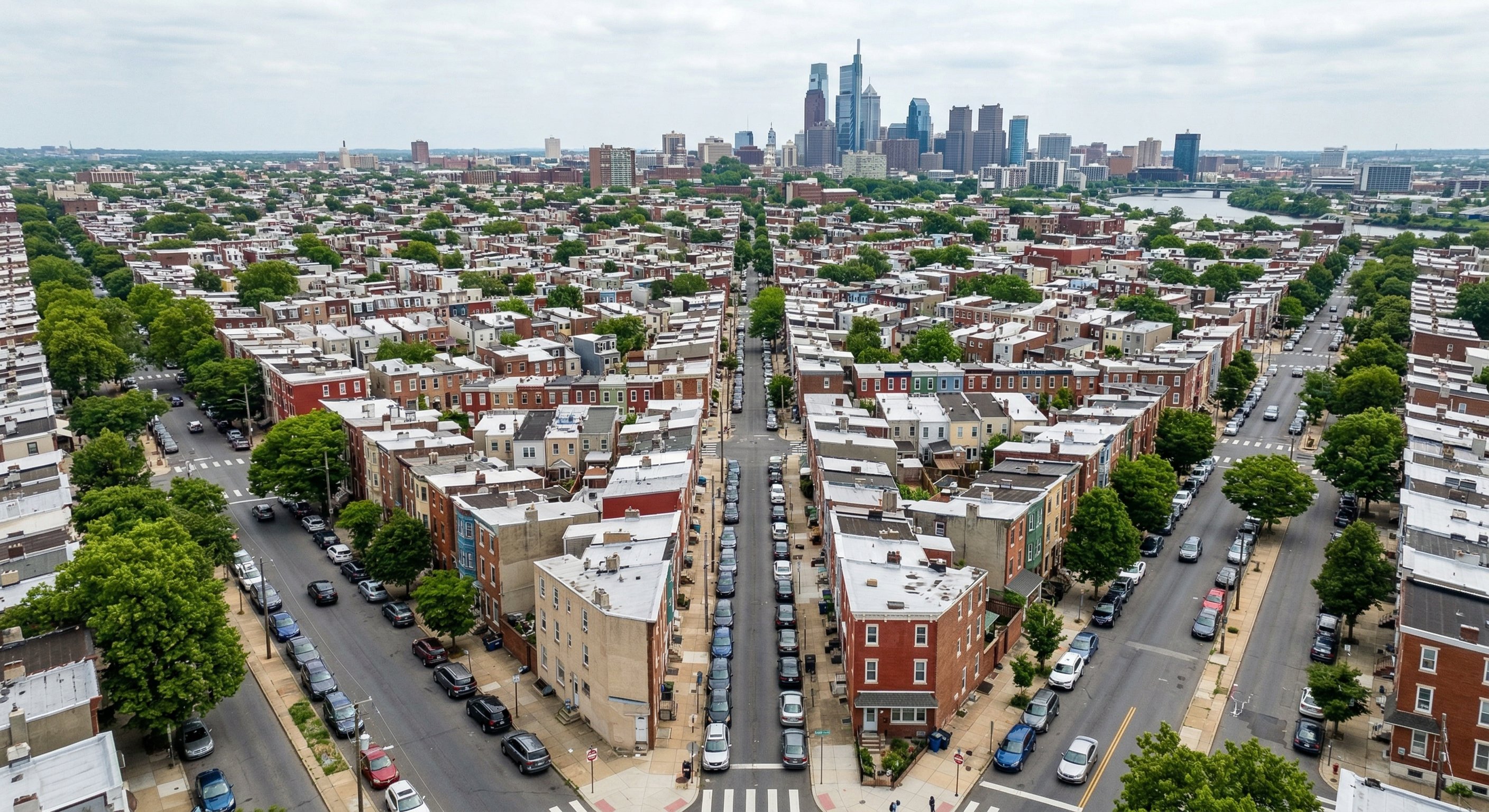 Aerial drone view of Philadelphia row homes and surrounding neighborhoods, showing the density of older housing stock in the city
