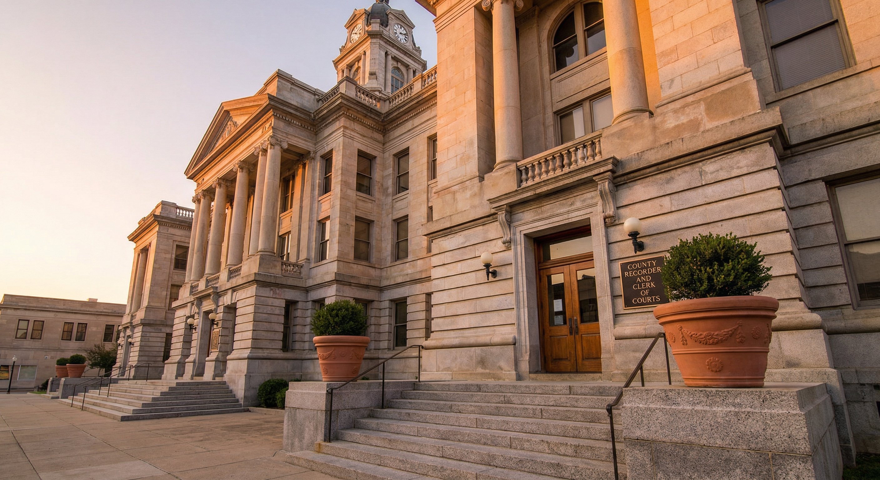 County courthouse exterior at dawn with public records signage