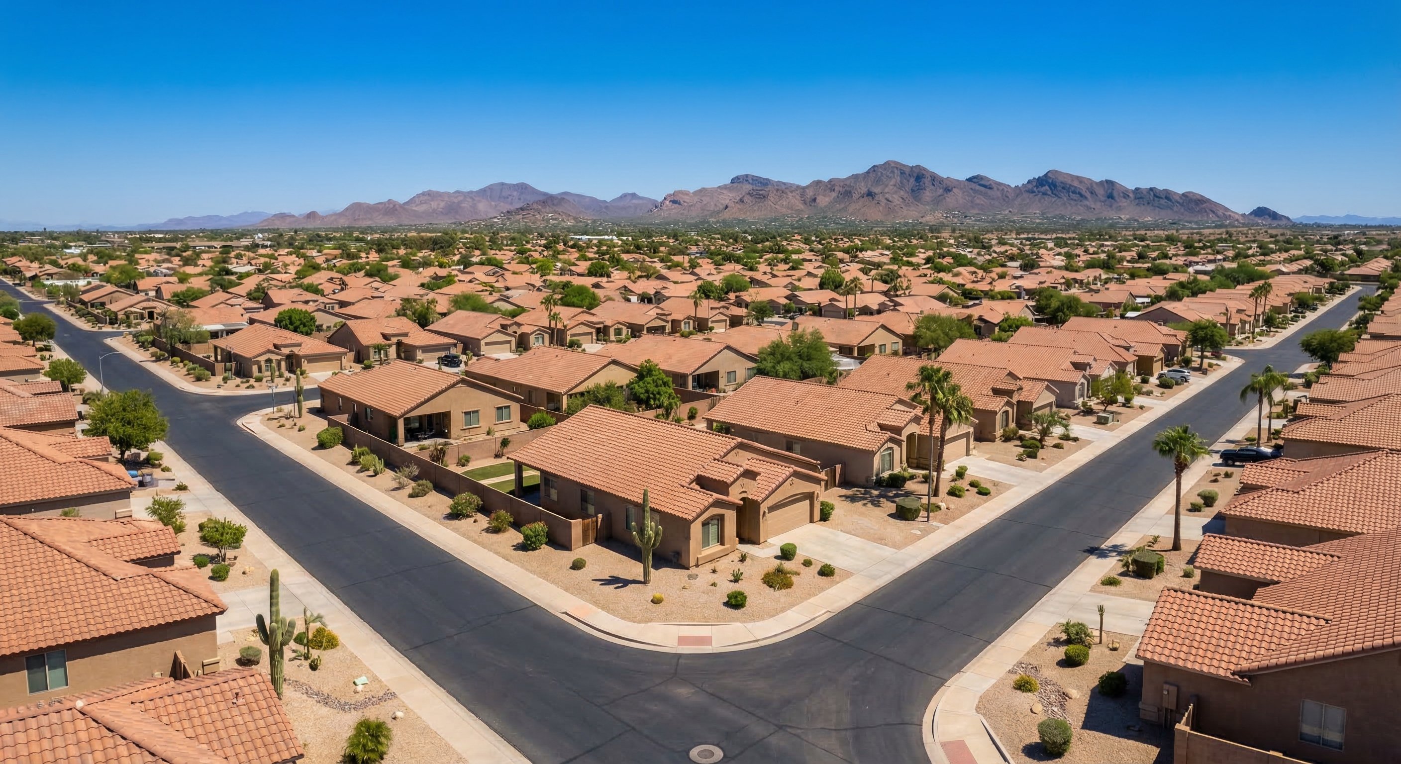Aerial view of sprawling Phoenix-area suburban neighborhoods showing single-story stucco homes and desert landscaping — Arizona tax lien investment market