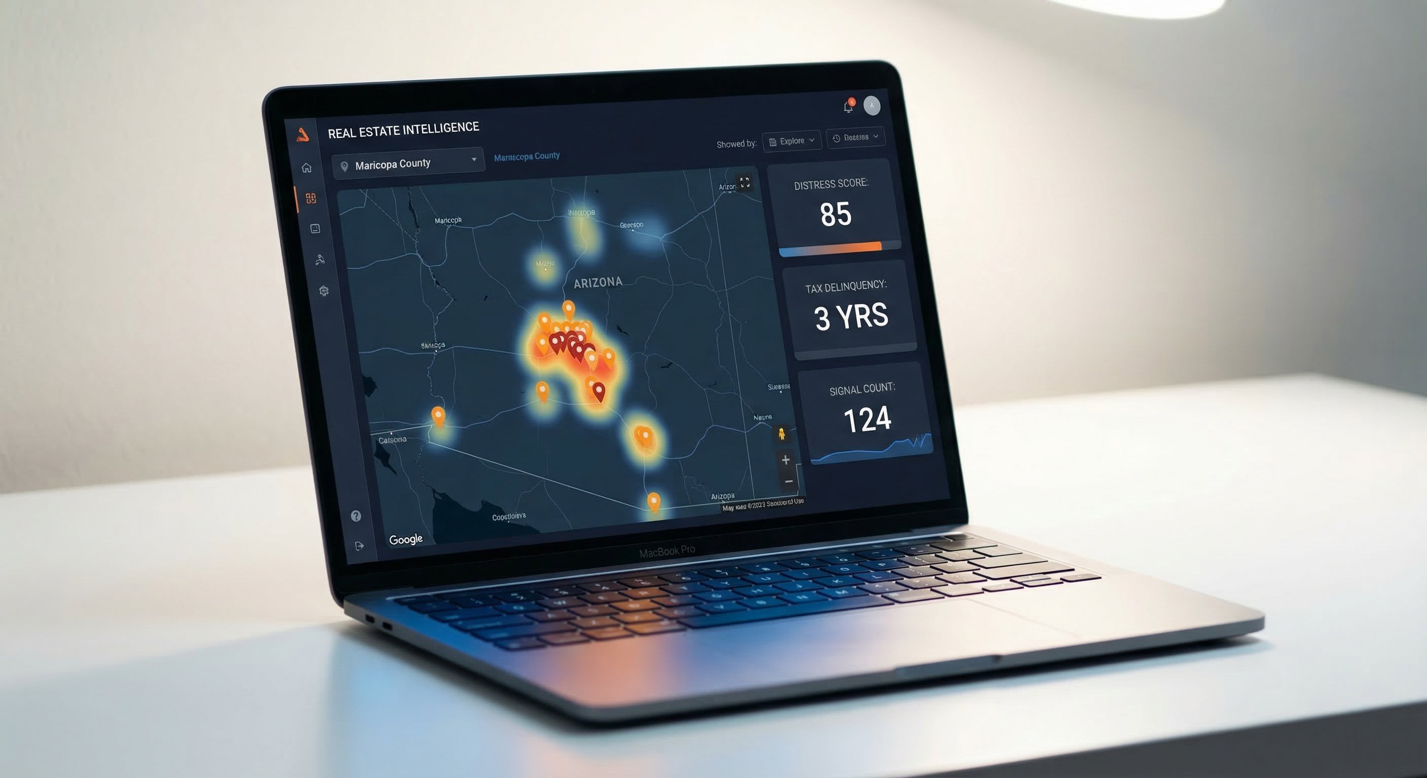 Dark-themed real estate analytics dashboard on a laptop showing Arizona Maricopa County map with orange highlighted tax delinquent property pins and distress score data cards