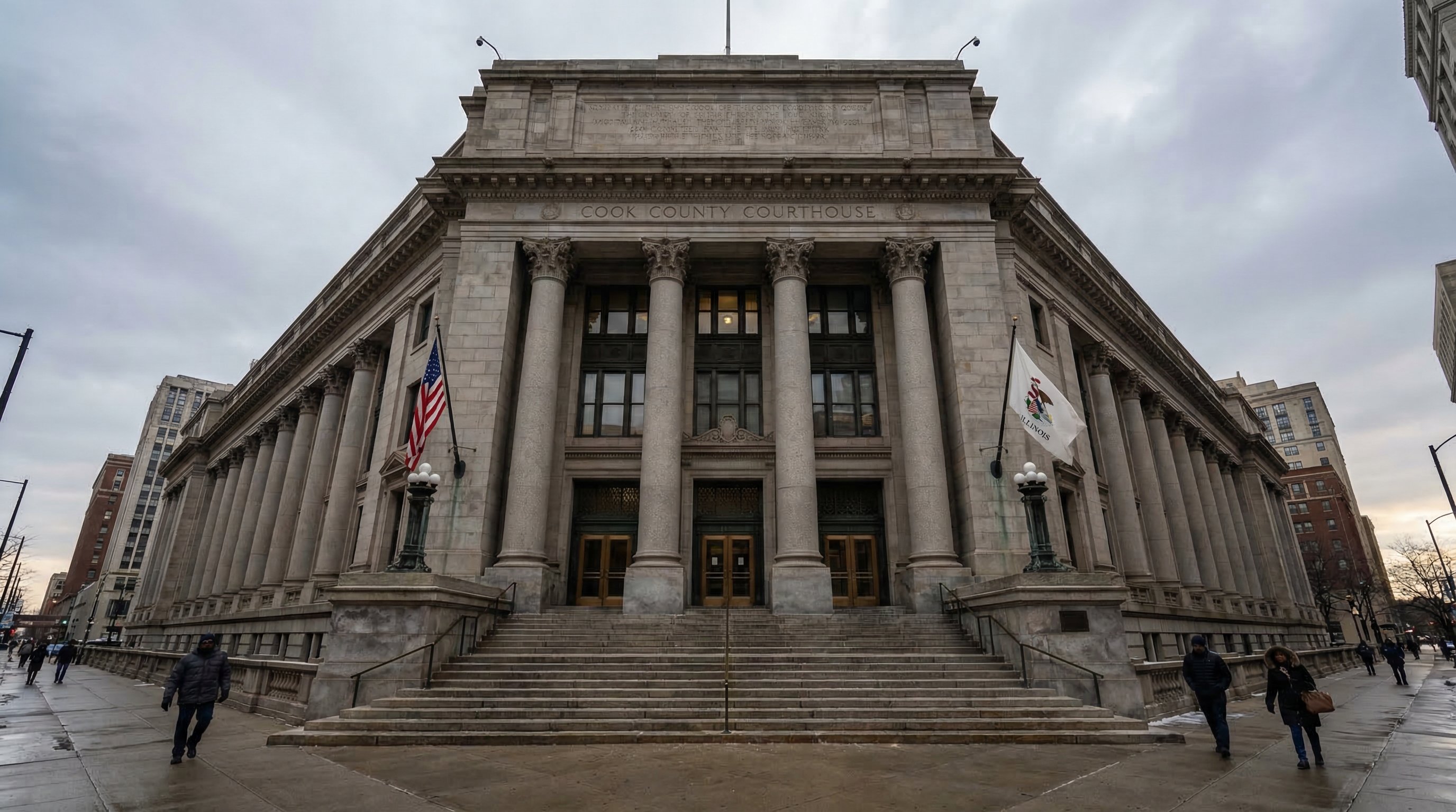 Cook County Courthouse exterior in Chicago — classical stone facade with wide granite steps, bronze doors, and Illinois state flag